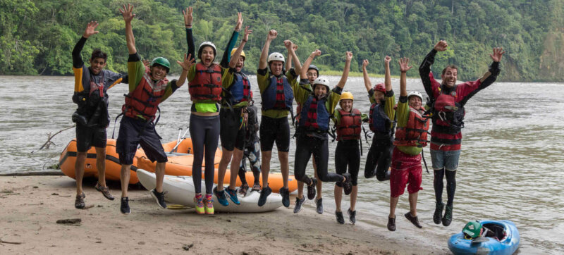 People jumping after a rafting trip in jungle in Southamerica