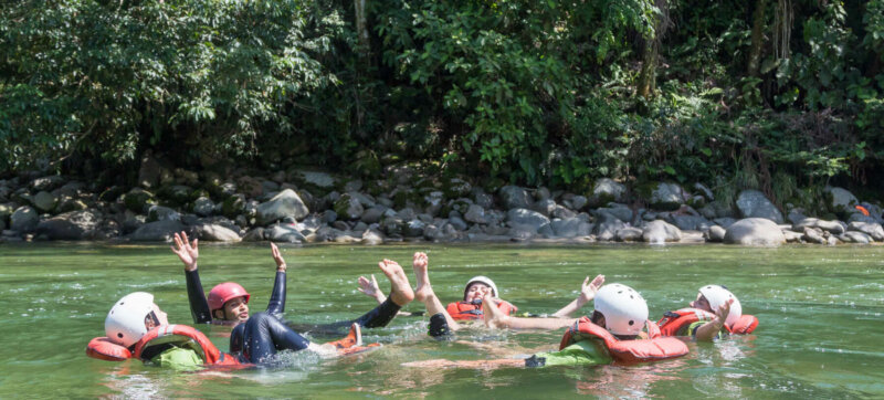 People in a river floating and swimming