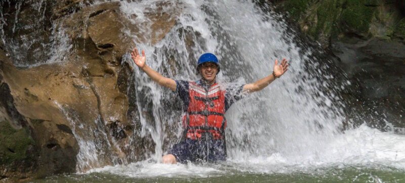 Man in a waterfall in Gran Cañon of Jondachi river