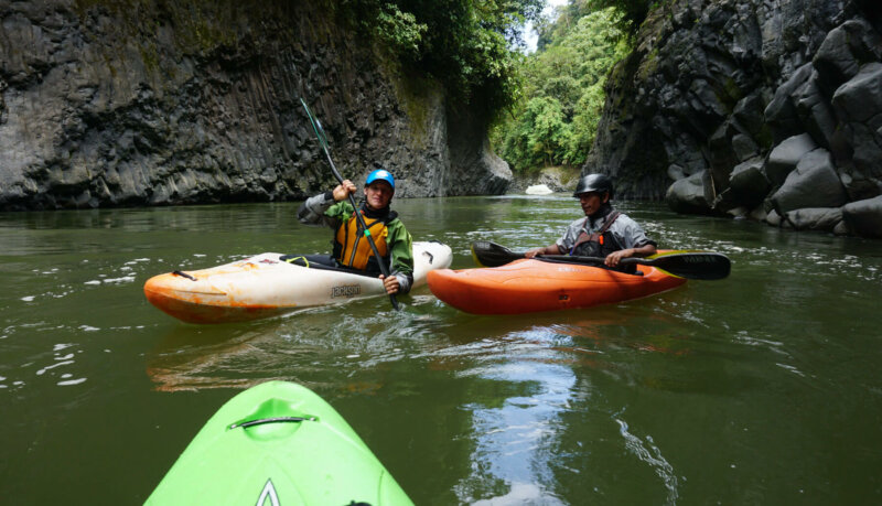 2 kayakers in the river in a kayak trip