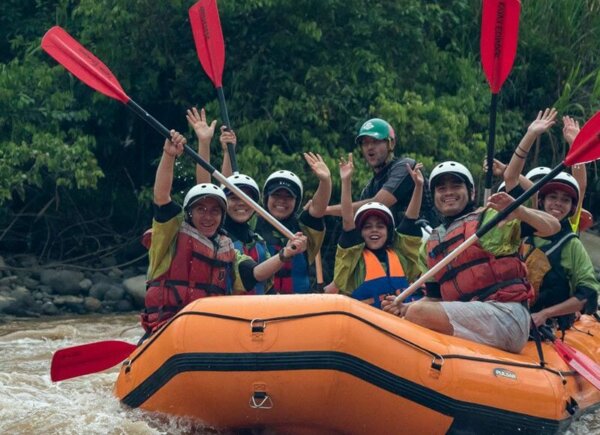 Rafting boat with happy people in the middle of the jungle